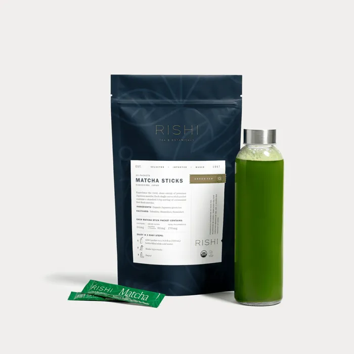 Rishi Matcha Sticks, slim green paper stick packets of organic Japanese matcha, shown with the seller's bag and a bottle of shaken matcha